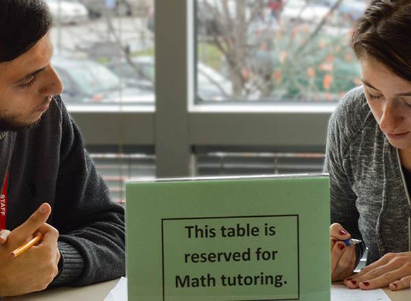 An image of two people studying.