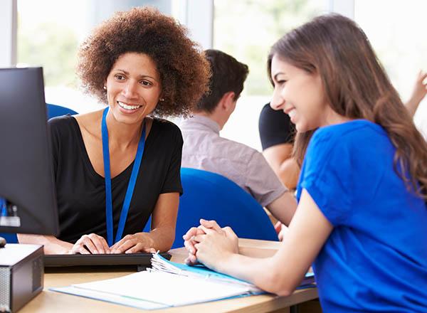An employee of a Student Services department providing advice to a student.