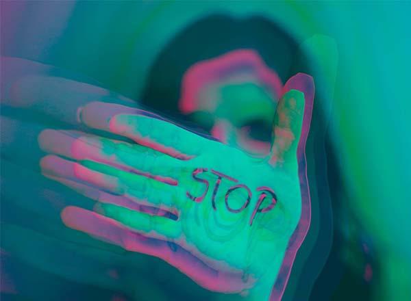 Hand with the word stop printed on the palm.