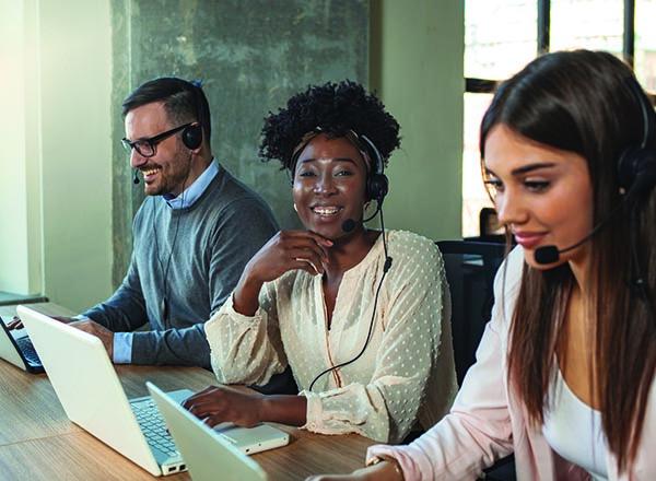 Three smiling customer service representatives