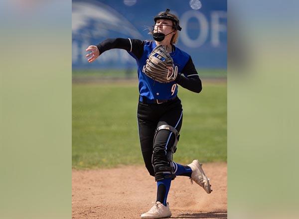 An image of a Hawk softball player throwing a ball.