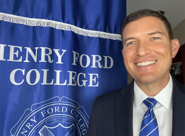 Russ Kavalhuna in front of HFC banner