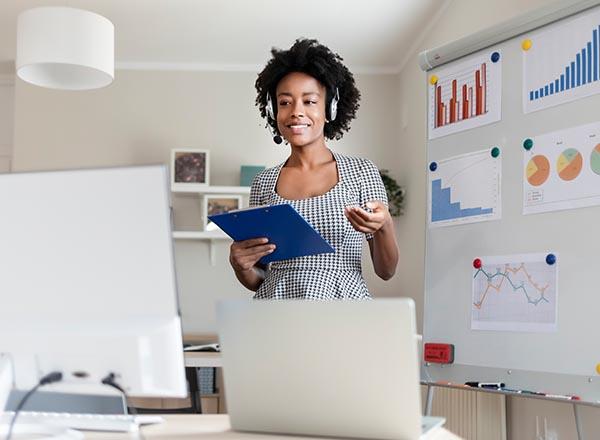 An image of a woman giving a virtual presentation from home.