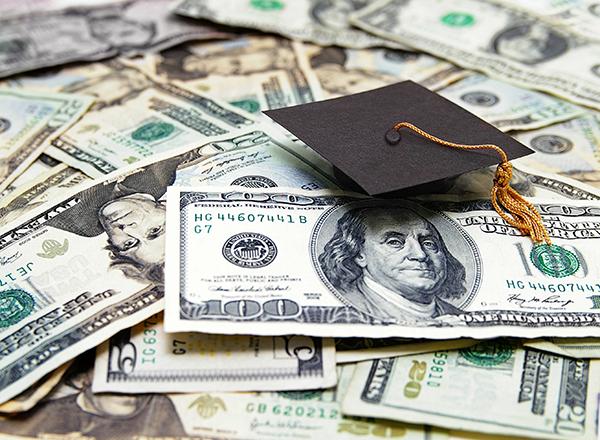 pile of money with a graduation cap