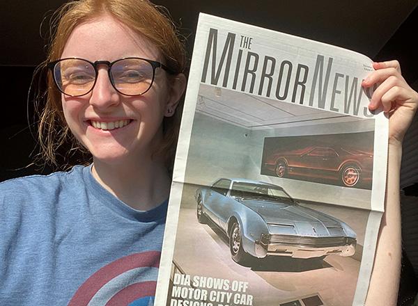 A picture of Lillian Grantham holding a copy of The Mirror News.