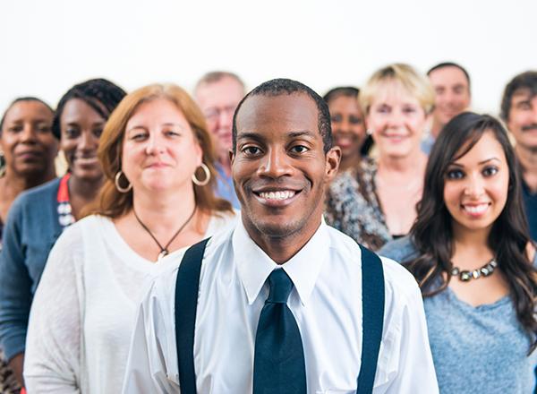 group of diverse individuals smiling at the camera