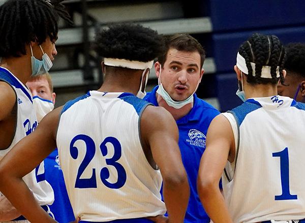 Photo of Coach Shepard and 3 Hawks players. 