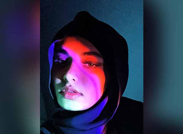 Safa Alamiri portrait with multi-colored lighting.