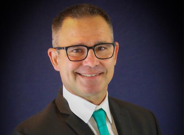 A headshot of Gary Enos.