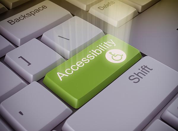 Computer keyboard with an accessibility green key.