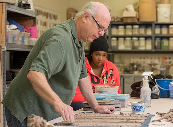 Steve Glazer working with clay and teaching in the ceramics studio.