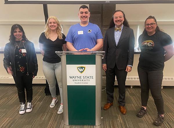 Marie Fawaz, Cortney Rinehart, Anthony Preston (at the Wayne State podium), Jesse Mason, and Dr. Kristen Dage. 
