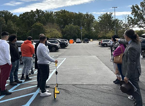 HFC physics and astronomy instructor Jesse Mason and his students viewing the sun on their solar system walk.