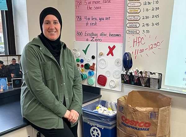 Mariam Hamid with recycling bins.