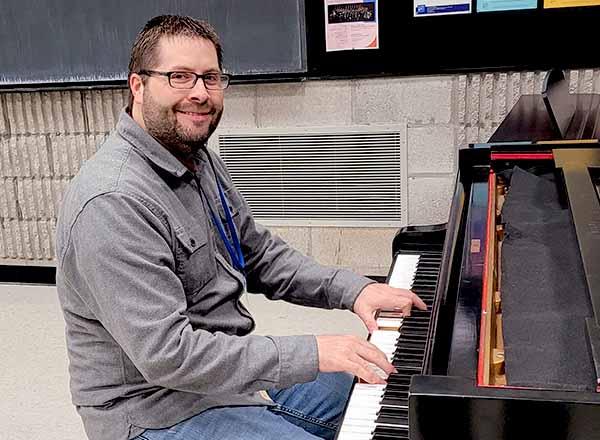 Jeremy Palmer playing a piano.