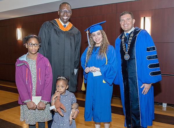 A photo of five people at Commencement