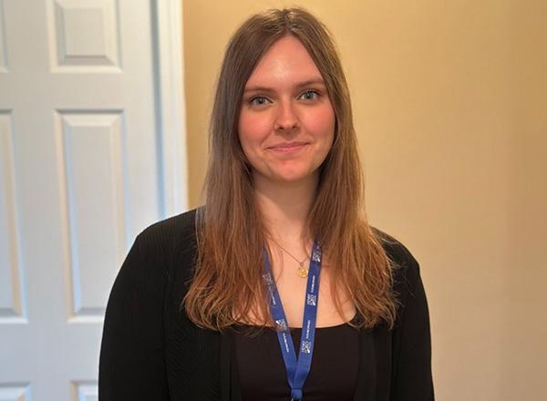  Alayna Kondraciuk has long medium blonde hair and is wearing a black shirt. 