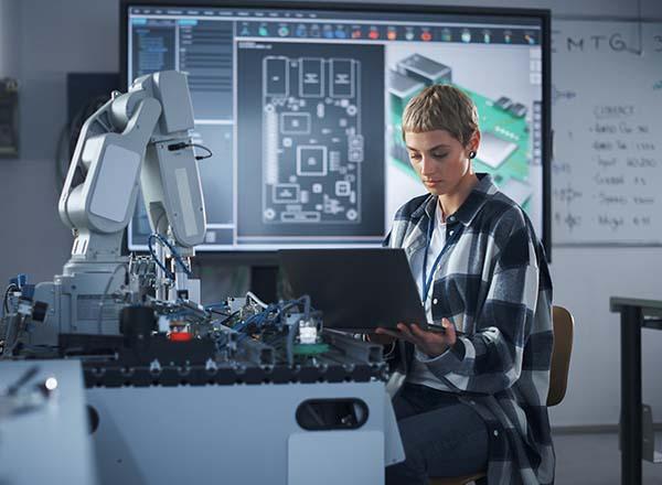 Female student working on a computer in a lab.