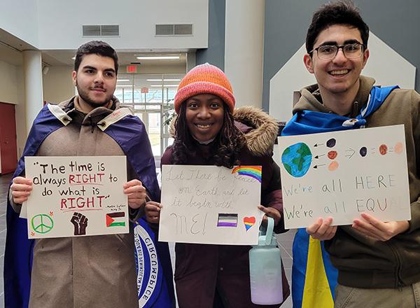 HFC students at MLK Peace Rally with signs and flags.