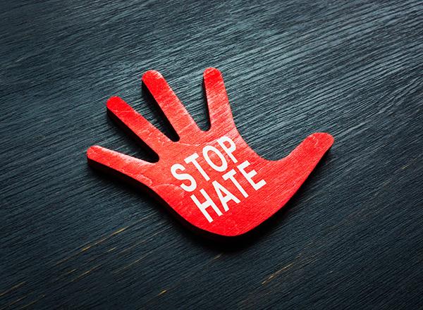 An image of a red hand that says stop hate.
