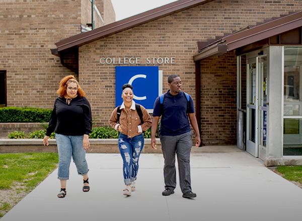 Students walking away from the entrance to the College Store.