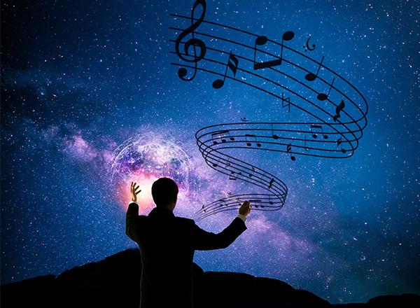 Silhouette of a conductor with a curving line of music on a celestial night sky.
