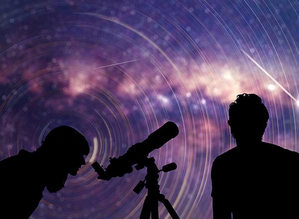 Astronomers looking at the starry skies with a telescope.