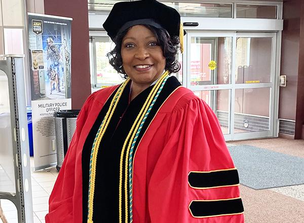 Dr. Cassandra Fluker in her graduation gown and hat.
