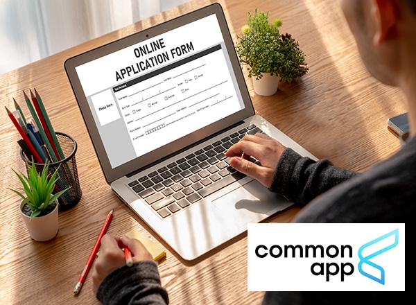 Person working on an online application form on laptop with Common App logo.
