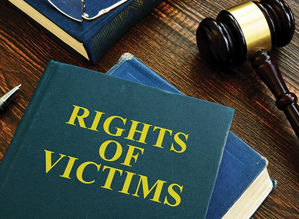 Rights of victims book on the wooden surface.