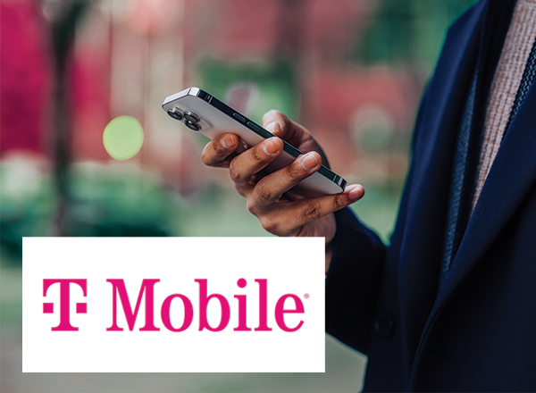 Business person on cellphone with T-Mobile logo.
