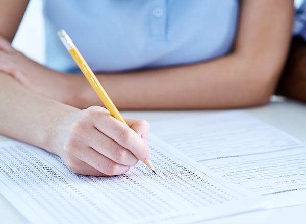Closeup of a student filling in a testing form.