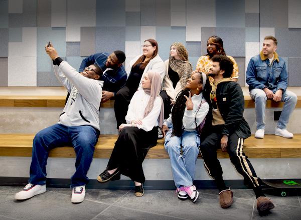 Students taking selfies in the new tech building study space.