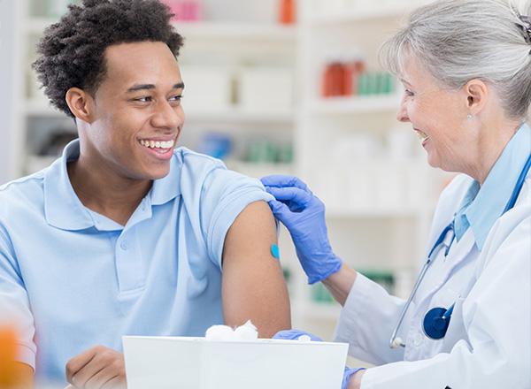 Man receives bandage on his arm after receiving a flu vaccine. 