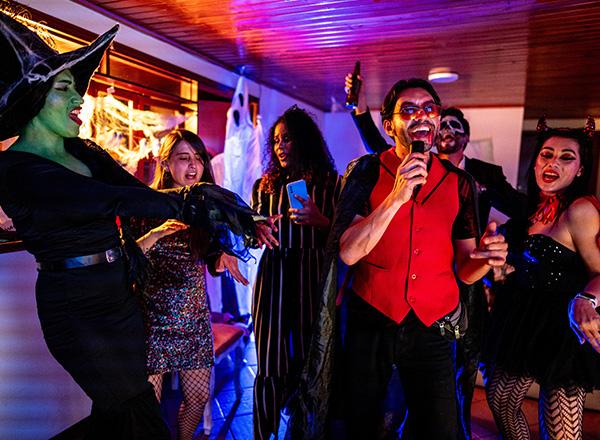 Singing karaoke with friends on a Halloween party