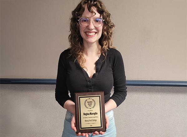 Regina Mareglia holding her award.