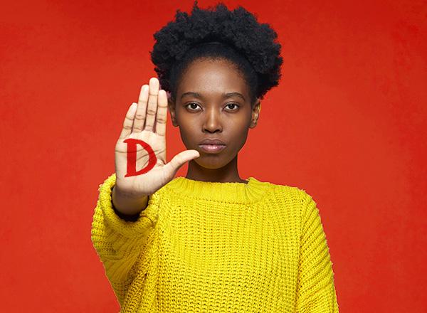 Women holding hand up like STOP with a red D on the palm
