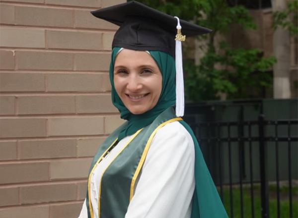 Abir Sayed headshot in cap and gown