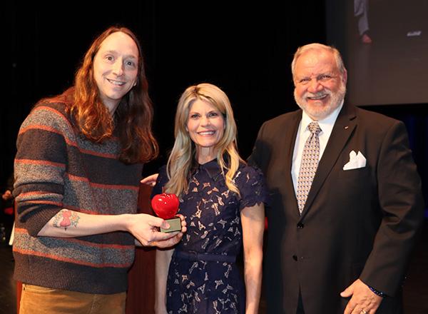 David Rochemont holding his award with the presenters. 