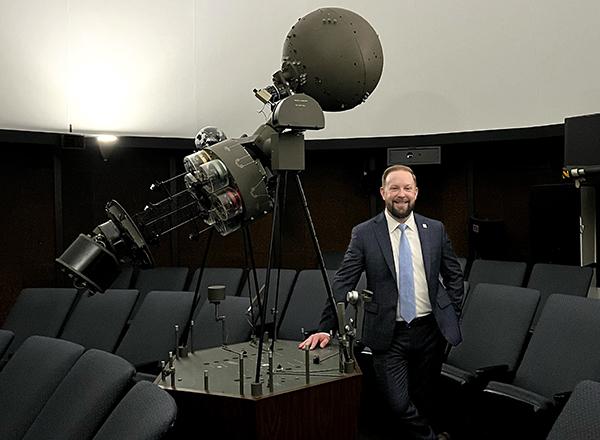 David Knezek in the planetarium next to the projection equipment