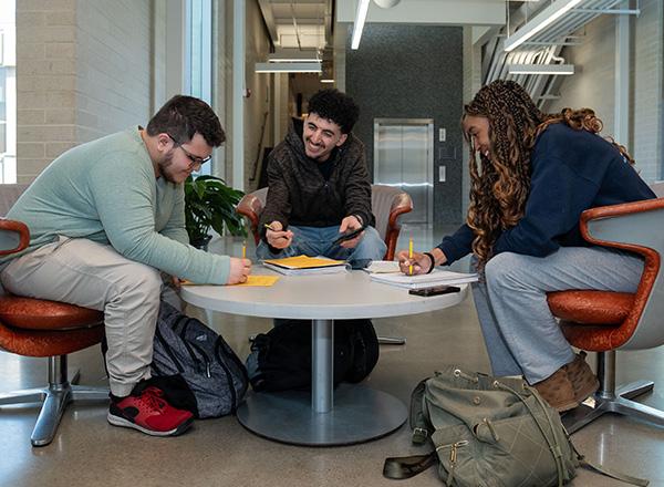 Three students brainstorming together.