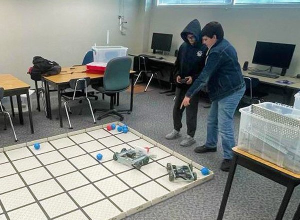 Engineering students using robots to play soccer.