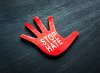 A red hand that says stop hate.