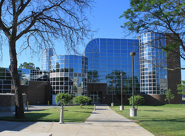 Building L on HFC's main campus, mirrored glass windows reflect the sky