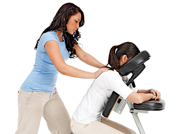 Photo of massage therapist massaging a person in a massage chair