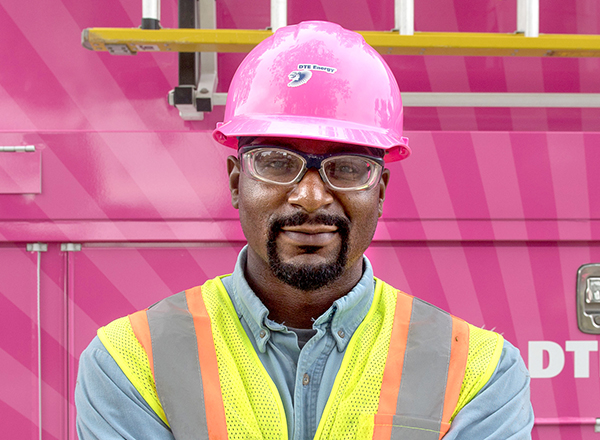 DTE energy worker in pink hardhat, smiling