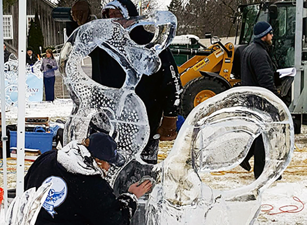 Henry Ford College Ice Carving Club members Mark Tampakes and Steve McCormick hard at work on their sculpture called “Invisible Touch.”