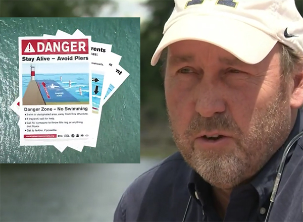 Screenshot from the video story: Jamie Racklyeft and warning posters about drowning